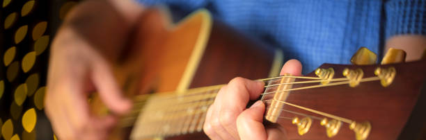 istock Man playing an acoustic guitar during a concert 1207578557