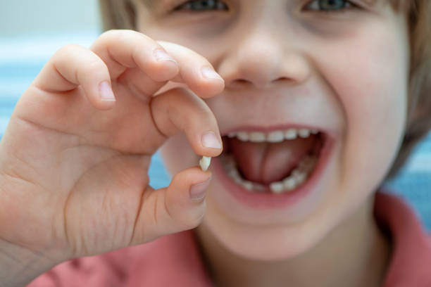 istock Cute Boy Smiling And Showing His First Lost Milk Tooth 1207578577