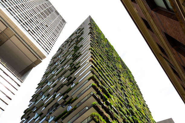 Sydney, Australia - February 16, 2020 Low angle view of apartment building with vertical garden in Sydney Central Park on George Street, Green wall-BioWall or living wall is a wall covered with living plants on residential tower
