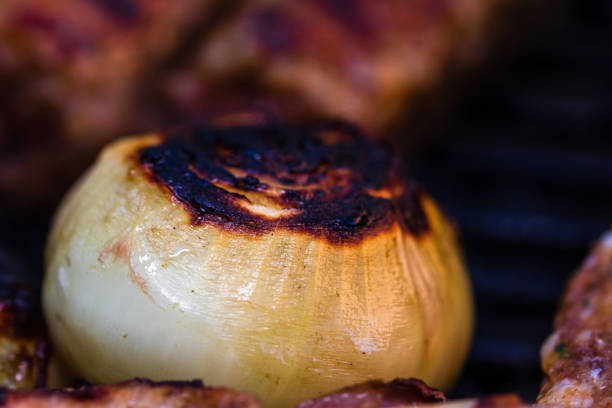 istock Grilled onion on a charcoal barbeque. Onion on BBQ 1207581959
