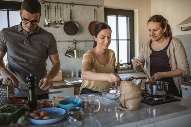 istock Group of friends preparing pizza 1207585717