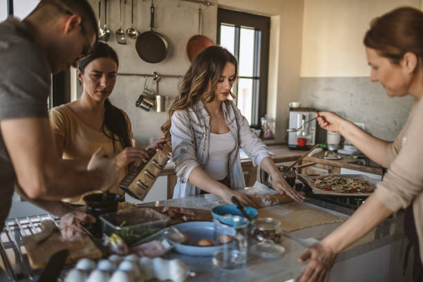 istock Group of friends preparing pizza 1207586192