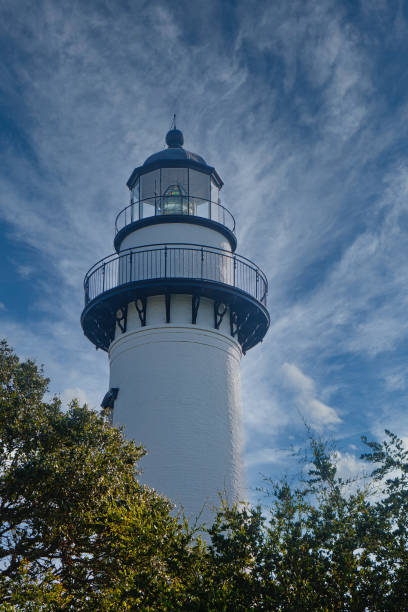 istock White Lighthouse Rising out of Trees 1207586243