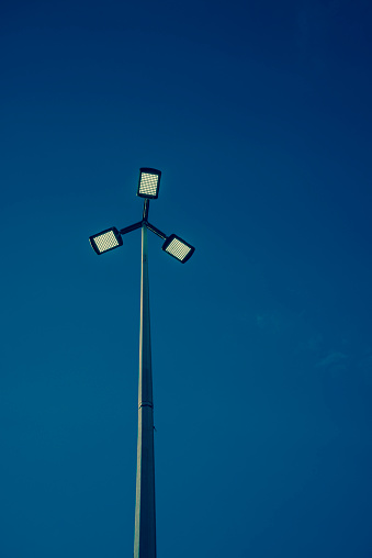 Street lamp against dark blue sky