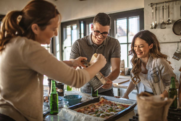 istock Group of friends preparing pizza 1207587858