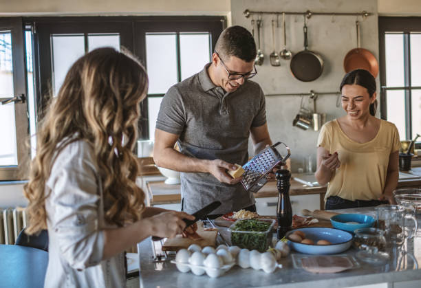 istock Group of friends preparing pizza 1207587920