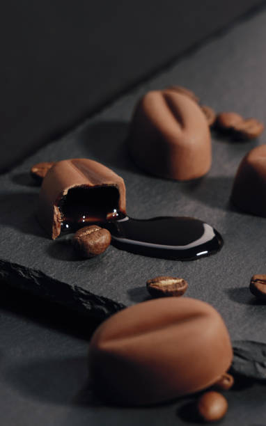 istock Coffee syrup leaked out of Broken coffee chocolate on stone plate 1207588151