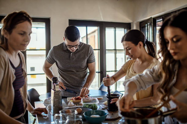 istock Group of friends preparing pizza 1207588259