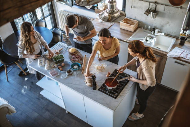 istock Group of friends preparing pizza 1207588831