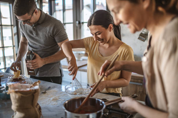istock Group of friends preparing pizza 1207589308