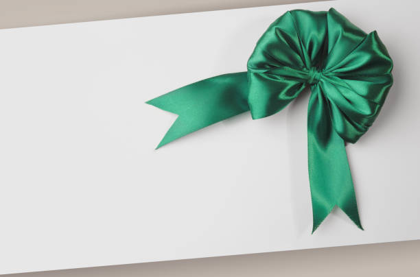 istock Greeting card template with green ribbon bow with white blank copy space 1207589314