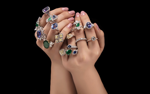 Hands showing diamond. Emerald.