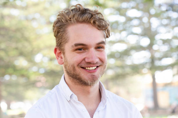 istock Portrait of smiling modern young man, background with copy space 1207595804