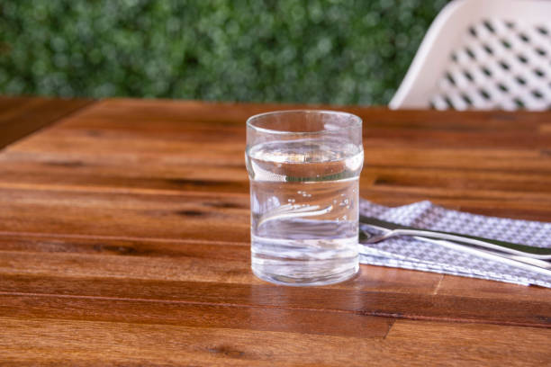 istock Glass of Water on a Table 1207598818