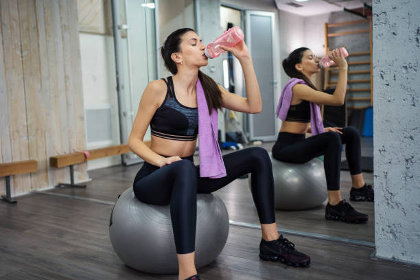 istock Athlete girl is resting and hydrated after a hard workout 1207598895