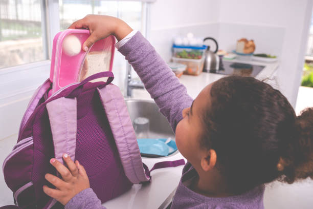 istock Girl packing lunch box for school / kindergarten. 1207599482