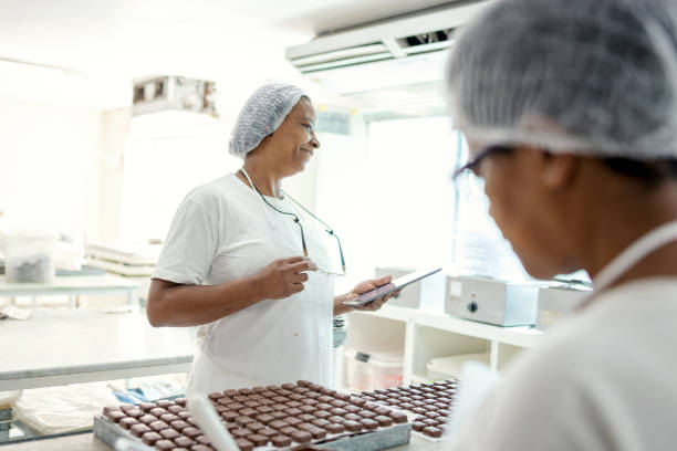 istock Women preparing chocolate in a chocolate factory 1207603386