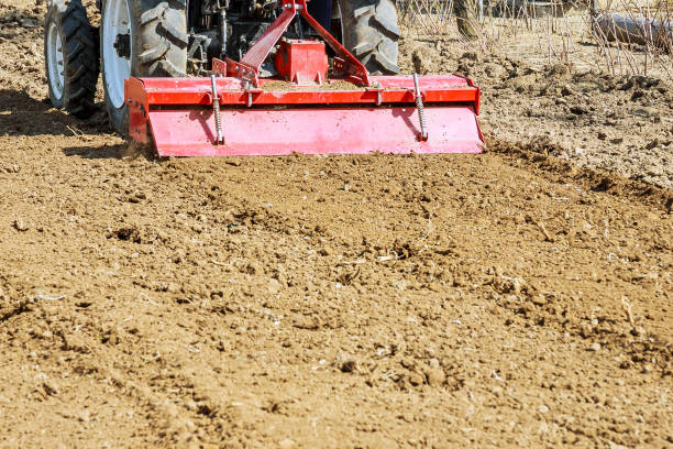 istock Farmer plows the field. Small tractor with a plow in the field. Cultivation. 1207606119