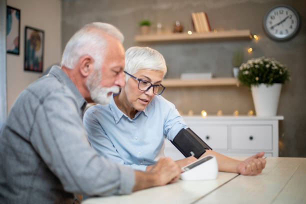 istock Senior couple checking their blood pressure. 1207607376