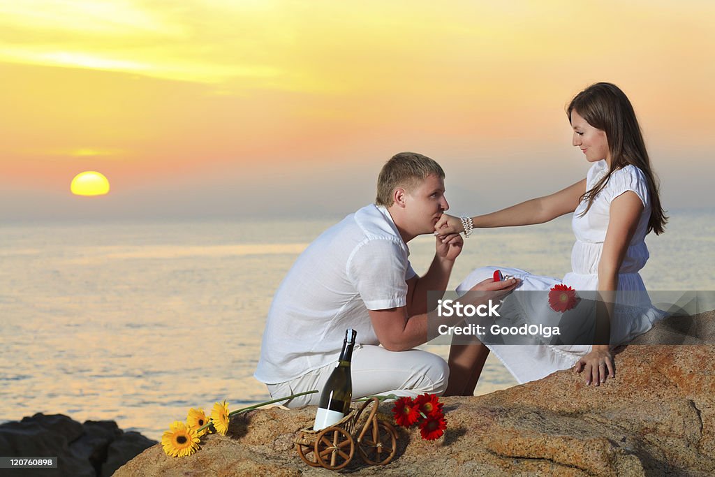 Offer of marriage Man proposing to girlfriend and offering engagement ring Bottle Stock Photo