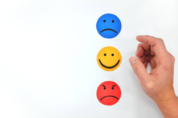 istock Hand choosing between happy, sad and angry face icon in white background. Customer service evaluation and review feedback. 1207612268