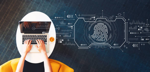 istock Fingerprint scanning theme with person using a laptop 1207615729
