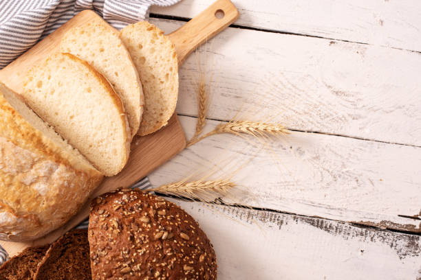 istock Fresh bread on wooden table. Top view with space for your text 1207615764