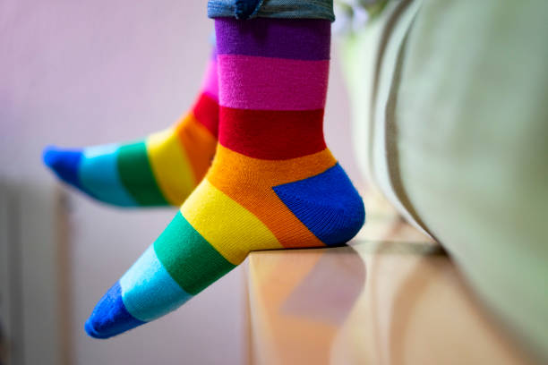 istock Feet with pride and colored socks on the bed. 1207619363