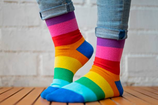 istock Feet with colored socks on a white background. 1207619365