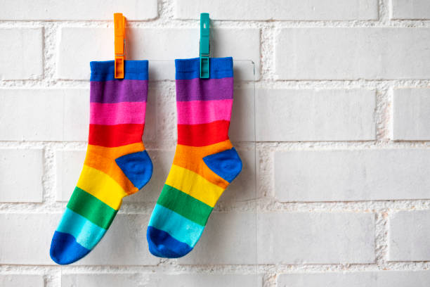 Colored socks stretched by tweezers.