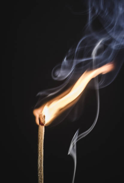istock A matchstick burning on black background with smoke 1207619415
