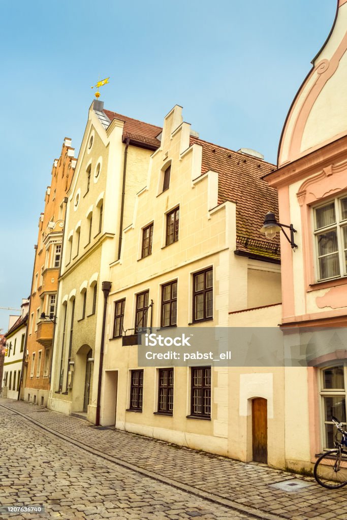 Alley with old traditional houses at Ingolstadt, Germany Brightly lit alleyway with old houses and cobblestone paved street in Ingolstadt City Stock Photo