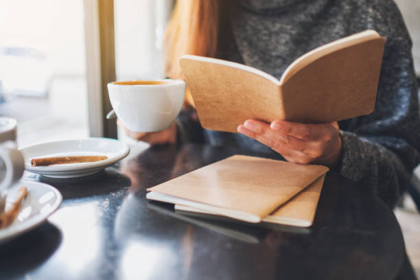 istock a beautiful woman reading a book while drinking coffee in the morning 1207643477