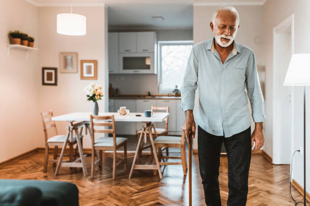 istock Elderly man with walking cane at home 1207644043