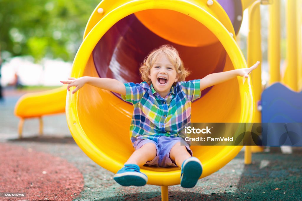 Child on playground. Kids play outdoor. Child playing on outdoor playground. Kids play on school …
