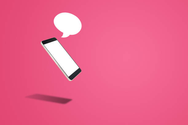 istock Black Smartphone with blank white screen and speech bubble on pink background. 1207646390