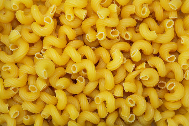istock top view of raw macaroni texture background 1207649229
