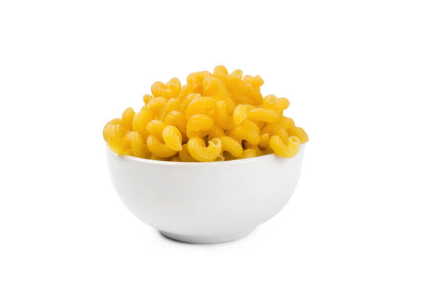istock raw macaroni in bowl on white background 1207649236