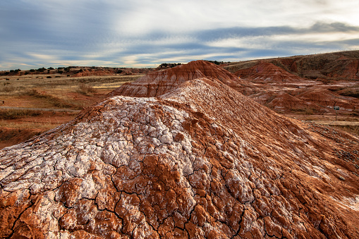 Palo Duro Canyon State Park, Texas, USA: eroded cliff side - Geologic time periods marked by major changes in the fossil record - rock strata covering the Permian age, Triassic age, Miocene-Pliocene age and at the top the Quaternary age - this cliff includes the Permian-Triassic (P-T) extinction boundary, colloquially known as the Great Dying, that took place about 248 million years ago. The extinction was caused by climate change. The main cause of extinction was the vast amount of carbon dioxide emitted by volcanic eruptions that created the Siberian Traps, which elevated global temperatures and acidified the oceans. Geological time scale, part of the Caprock Escarpment - Texas Panhandle.