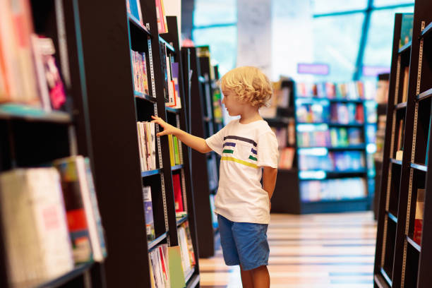 istock Child in school library. Kids reading books. 1207655346