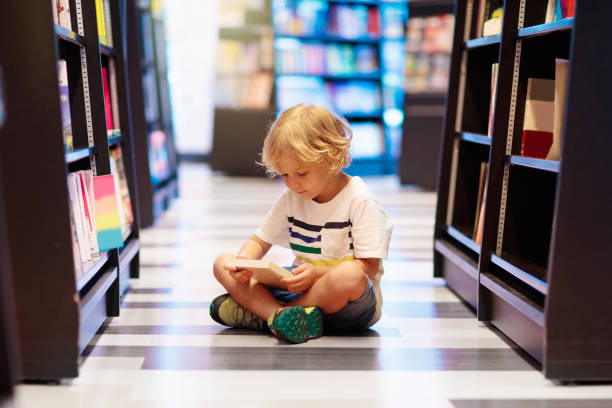 istock Child in school library. Kids reading books. 1207655418