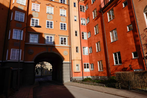 Charming cobblestone street by Bastugatan with traditional yellow houses in the sodermalm district of stockholm, sweden, showcasing scandinavian architecture
