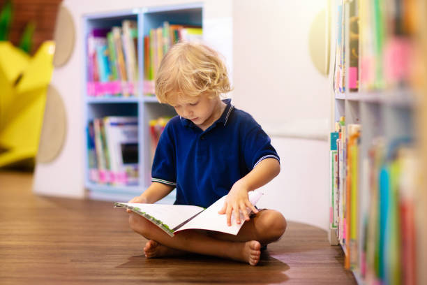 istock Child in school library. Kids reading books. 1207655620