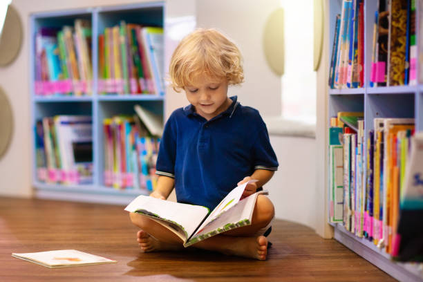 istock Child in school library. Kids reading books. 1207655747