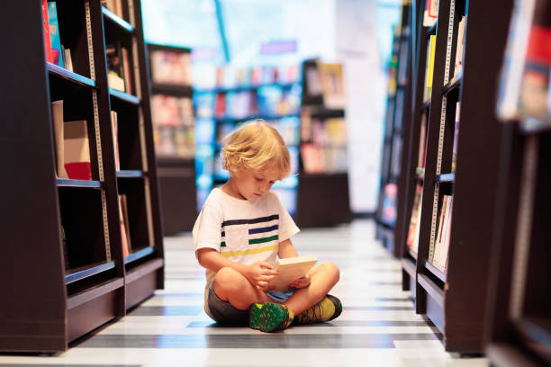 istock Child in school library. Kids reading books. 1207655888