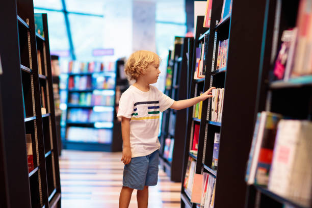 istock Child in school library. Kids reading books. 1207655967
