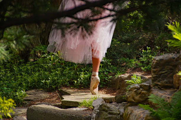 Pink ballerina shoes on young girl in the field