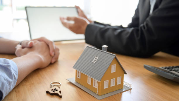istock Close up view of House loan agent using  blank screen tablet on wooden table background 1207660241