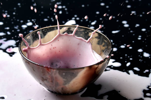 istock Homemade yogurt with berries. Splash from falling berries 1207662347