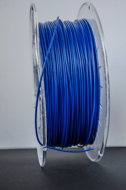 istock Blue plastic for 3D printing on black and white background 1207665568